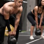 Athletes lifting kettlebells in a cross training box