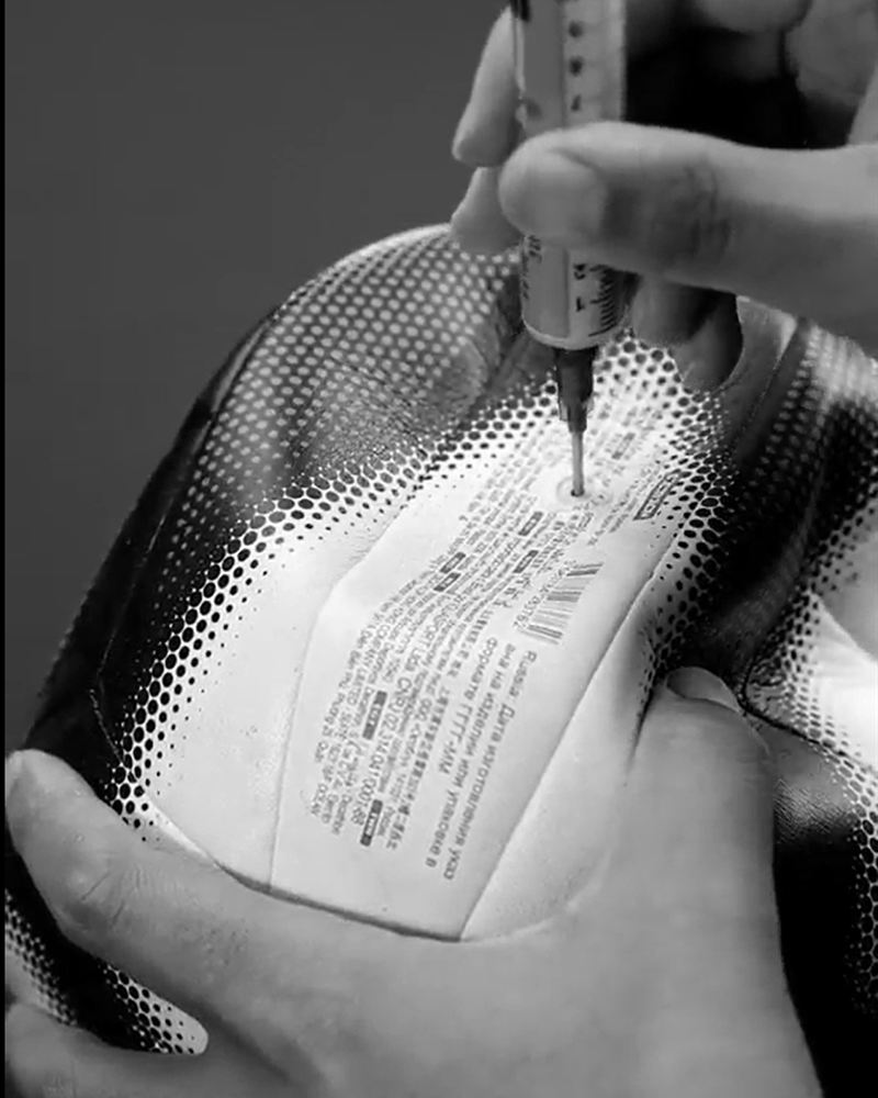 Injecting ULTRAGRIP Furo Zero into a ball with the syringe