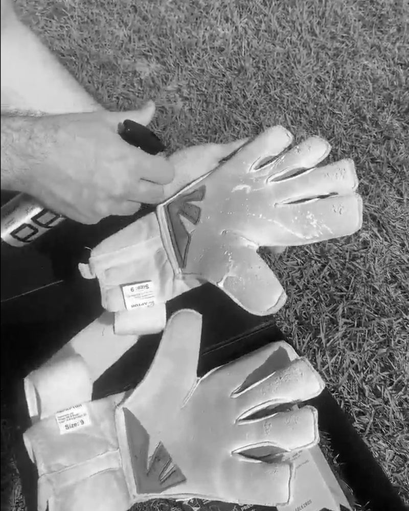 Applying ULTRAGRIP Gloves Pro on goalkeeper gloves on the pitch