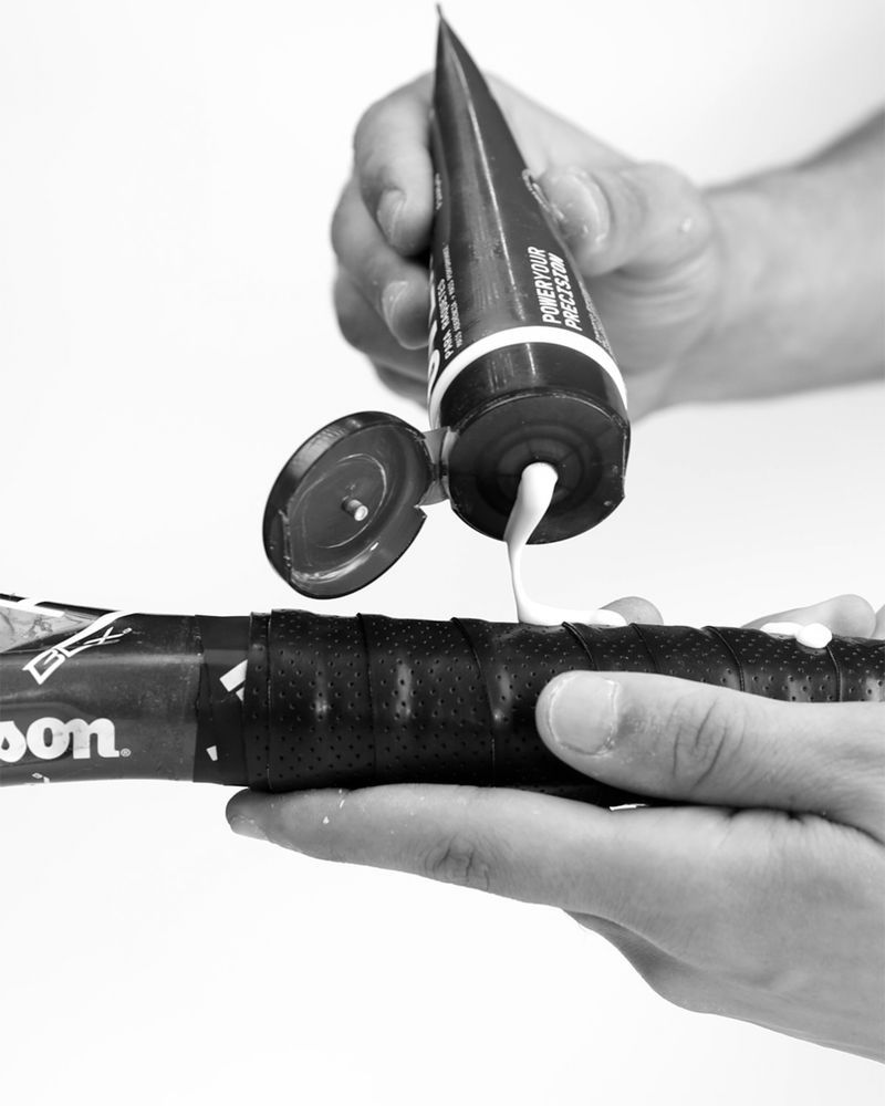 Applying ULTRAGRIP Overgrip gel to a racket overgrip