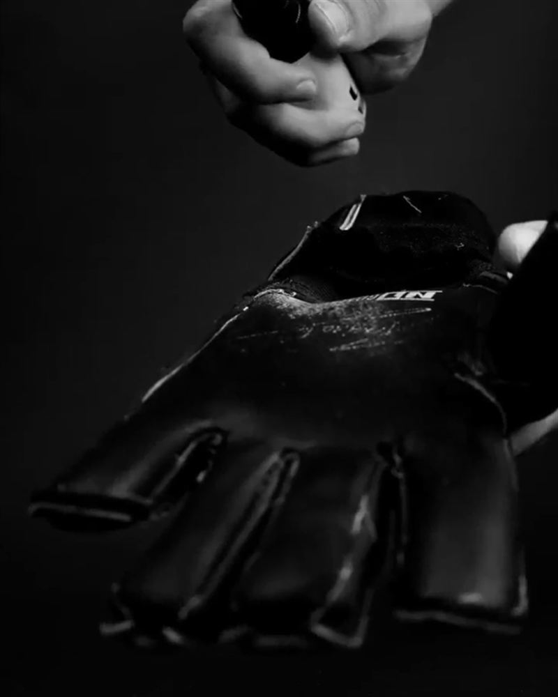 Spraying ULTRAGRIP for Gloves on a goalkeeper glove