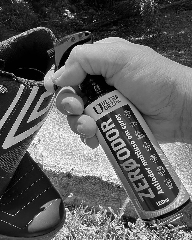Spraying ULTRAGRIP Zero Odor inside a football boot